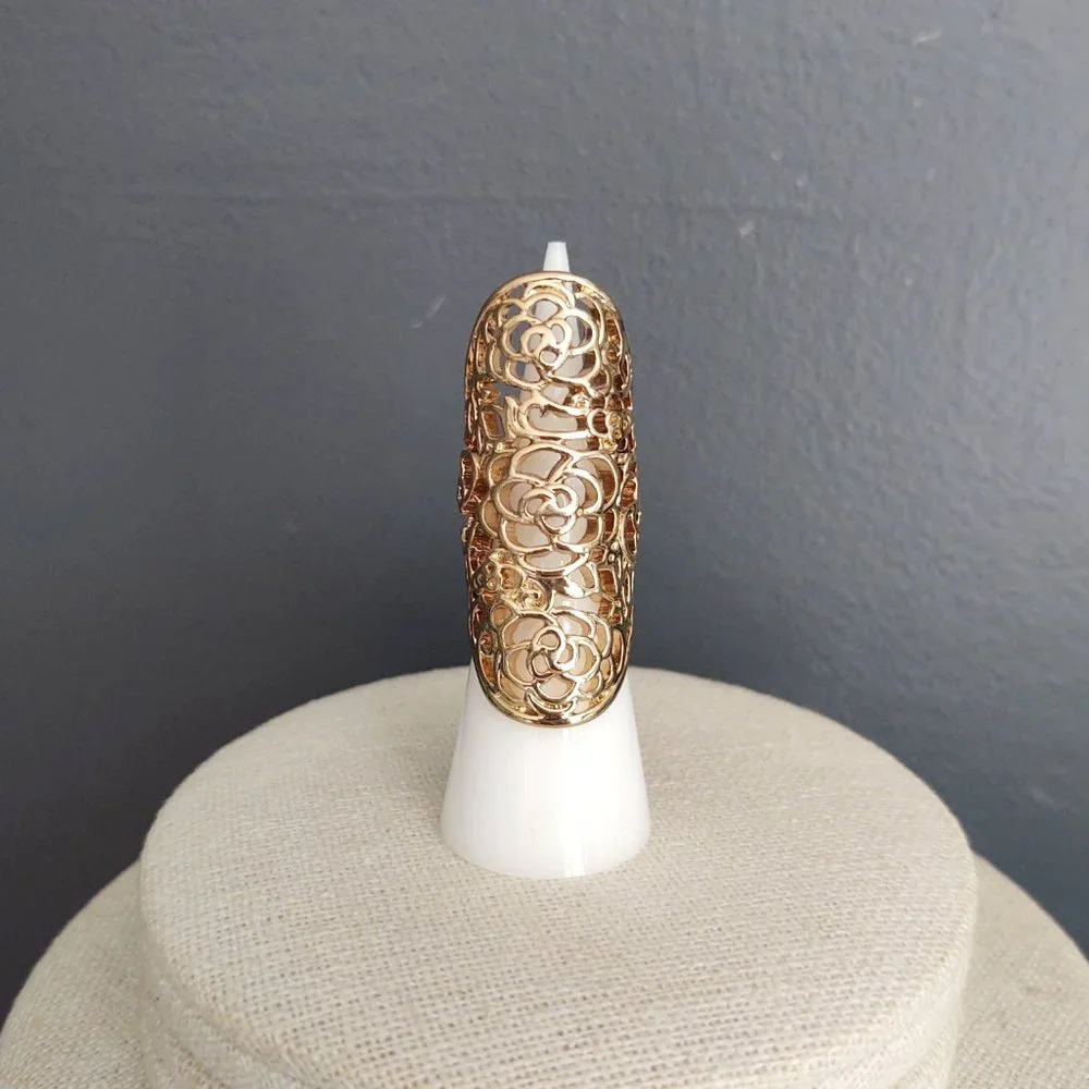 Long, open scroll design gold ring